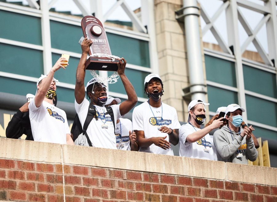 Adrian Delph, App State junior guard, lifts the Sun Belt Championship trophy for the fans in attendance at the welcome-home celebration Tuesday afternoon. Delph recorded 22 points in the final versus Georgia State. This is the first-ever Sun Belt basketball championship win in school history.