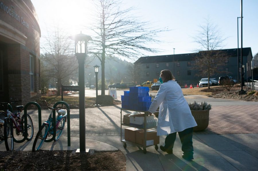 Medical workers bring supplies into the Holmes Convocation Center on Thursday in preparation for the App State vaccination rollout.