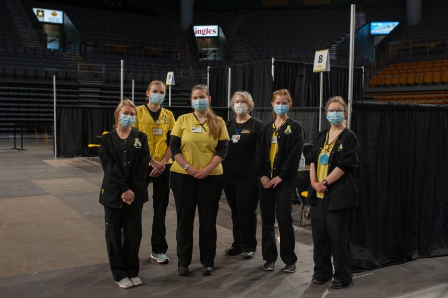 A group of nursing students administering J&J vaccines pose for a portrait. 