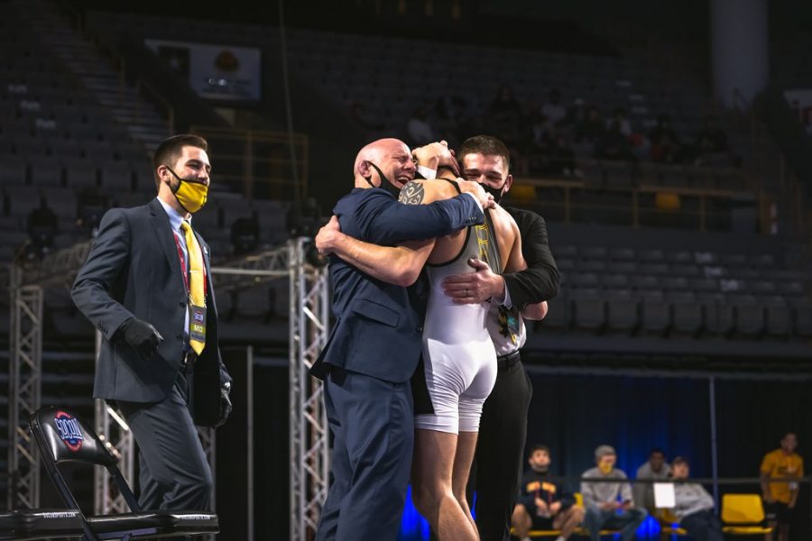 App State redshirt junior Cody Bond embraces head coach JohnMark Bentley and assistant coach Ian Miller after winning an individual SoCon title on Sunday night in Boone. Bentley said part of the reason the match was so emotional was because of how far Bond has come on his journey at App State.