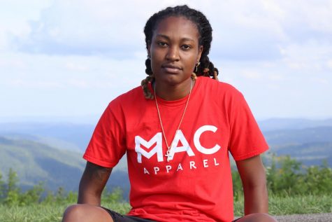 Maya Calder wearing a shirt from her clothing line, Mac Apparel. 