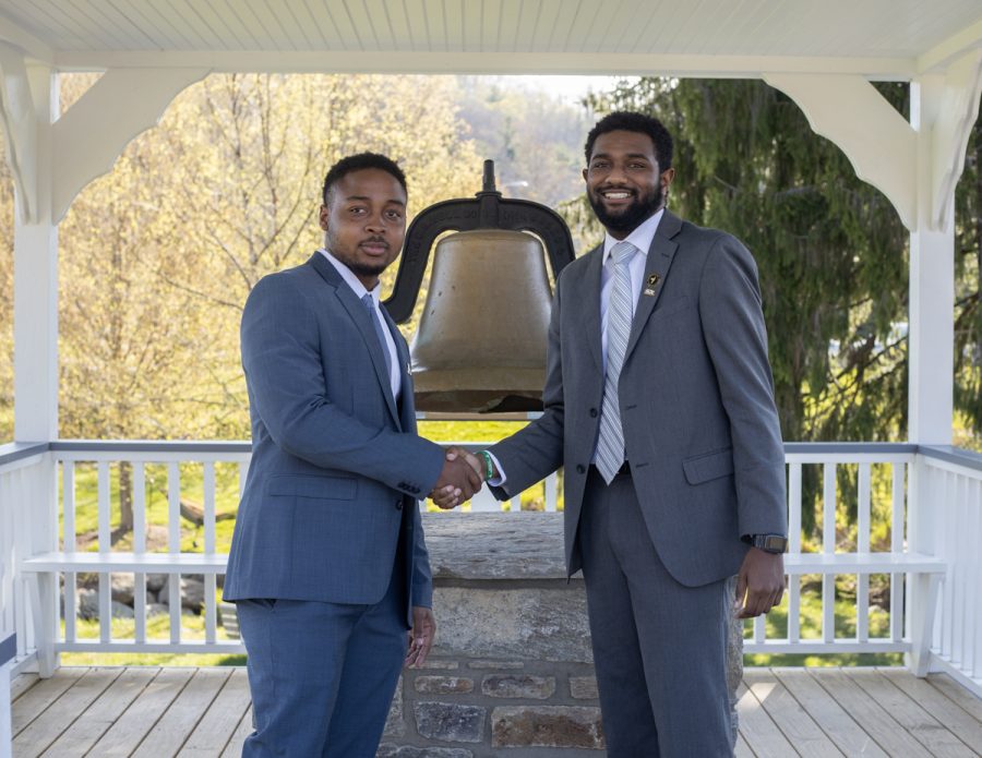 Bailey Gardin (right) and DJ Evans (left) shake hands during their swearing-in ceremony, April 28, 2021. 