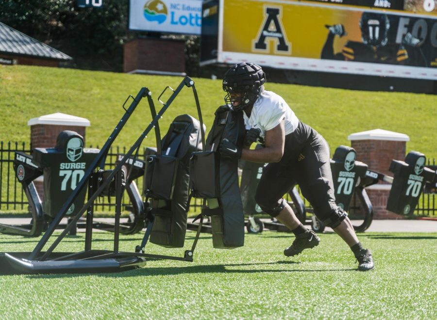 App State freshman offensive lineman Jaden Lindsay hits a sled during spring practice this season. “He has a long way to go, but he’s come a long way in nine practices,” Mountaineers head coach Shawn Clark said. 