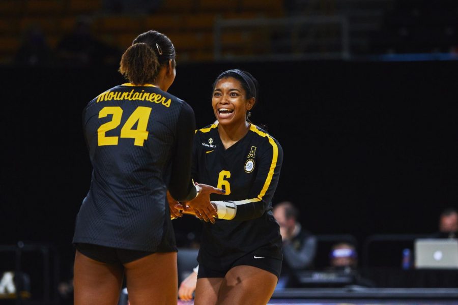 Senior Grace Morrison celebrates with her teammate, junior Daryn Armstrong, after scoring a point. Armstrong enters her senior season after totaling 55 kills and 52 blocks over her first three years in the Black and Gold. 