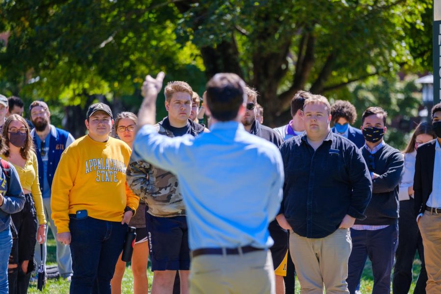 Jackson, a Democrat, engaged with political opponents like College Republicans President River Collins, seen here listening to Jackson speak.