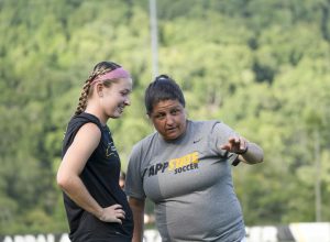 Women’s soccer head coach Sarah Strickland coaches junior forward  Hayley Boyles ahead of their 2-1 win against the University of South Carolina Upstate. Strickland has led her squad to a 4-6-1 start to the 2021 season. 