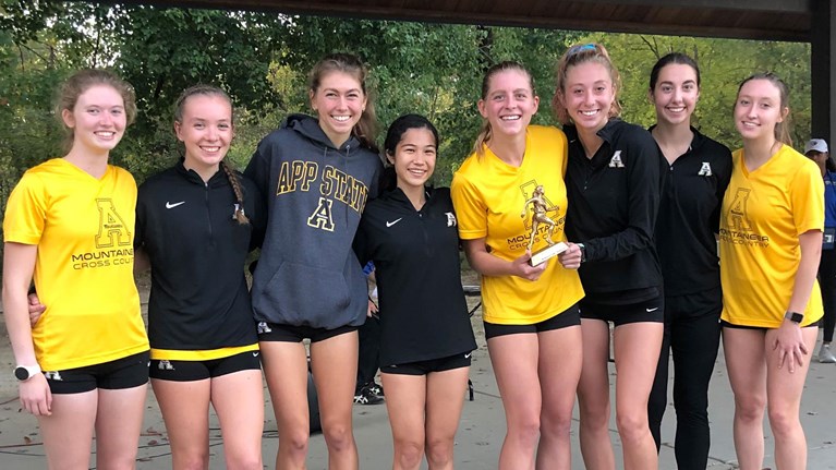 The Mountaineer women’s cross country team celebrates their first place finish at the Wildcat XC Classic. The women secured nine of the top 10 spots en route to their victory. 