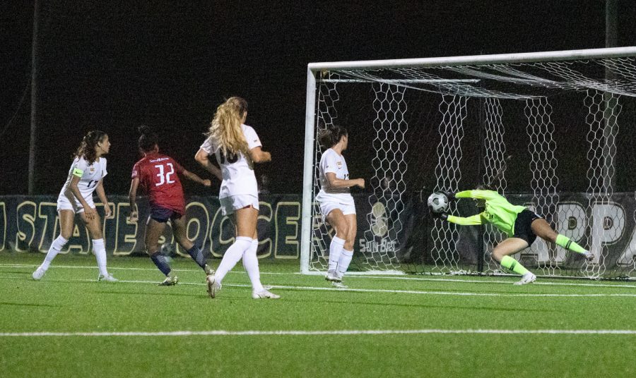Junior goalkeeper Kerry Eagleston makes a diving save to prevent a South Alabama goal Sept. 30. Eagleston totaled seven saves on the night. 