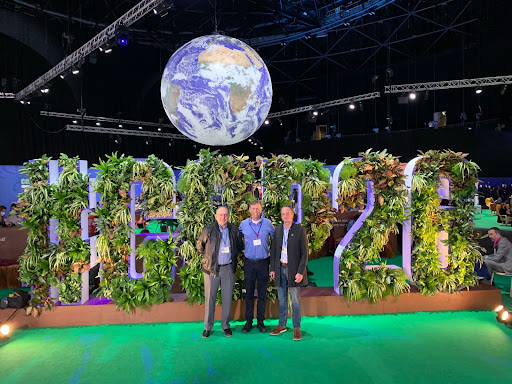 From left to right: Martin Meznar, Lee Ball, Dave McEvoy posing in front of the COP26 sign showcasing their attendance at the conference.