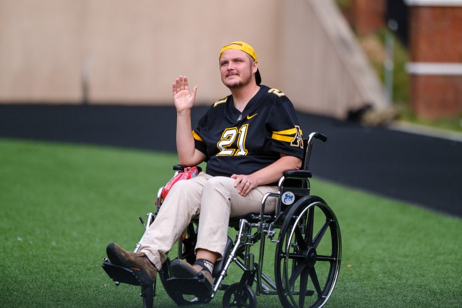 Michael Morgan, a 2019 App State graduate, waves to the crowd while being honored as Alumni of the Game at the home opener versus Elon.