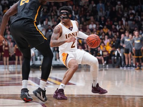 Iona’s Elijah Joiner is guarded by App State senior forward James Lewis Jr. in men’s basketball’s season opener. Lewis Jr. put up seven points and nine rebounds against the Gaels.