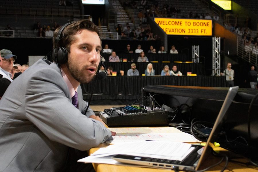 Matt Present calls the Nov. 18 matchup with Charlotte from the scorers table. Present’s second home game behind the microphone concluded in a one-point Mountaineer defeat.