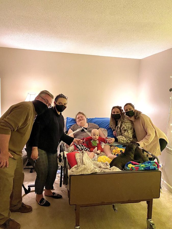 The Smithson family gathered around Alexis for a photo, Dec. 23, 2021. 
