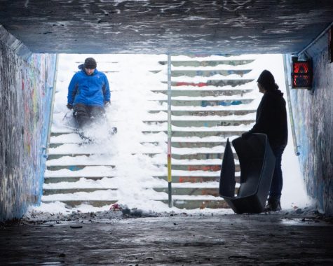 Students slide on the snow into the Free Expression Tunnels on campus Monday, Jan. 17, 2022.