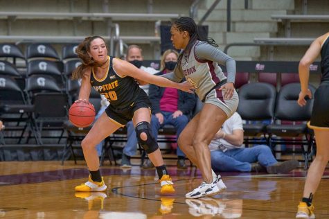 Senior guard Brooke Bigott shields off a Little Rock defender as the Mountaineers capture an 11-point conference win. 