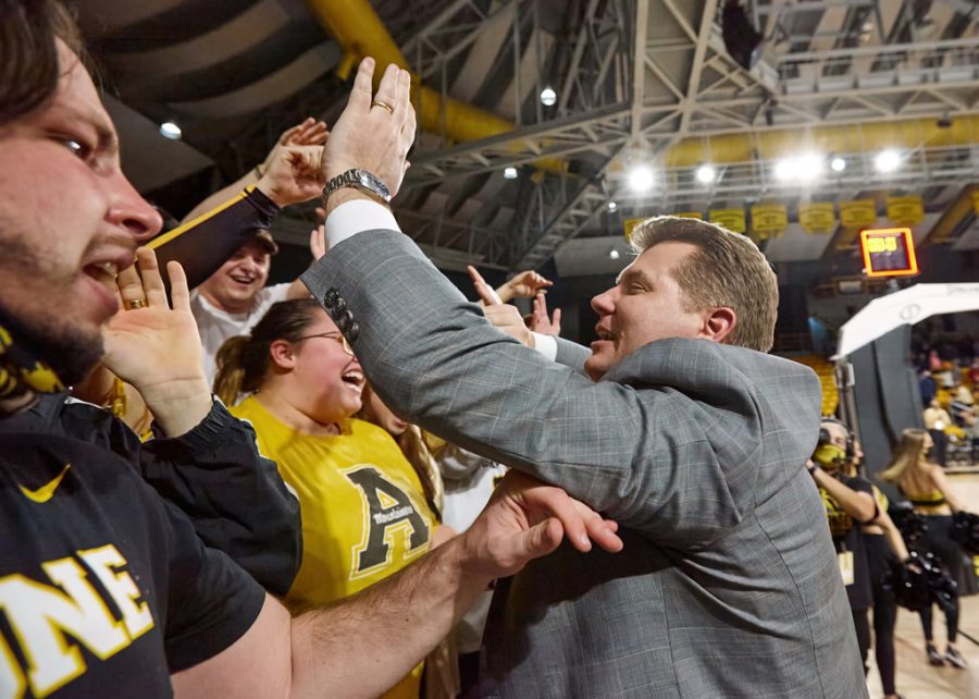 Head coach Dustin Kerns celebrates with the Mountaineer student section following App States victory over Arkansas State. 