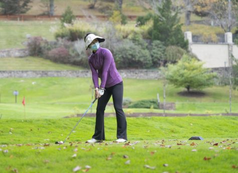 Sophomore Hannah Wang tees off during a 2021 team practice at Hounds Ear Club in Boone. 