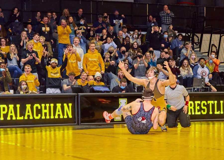 Redshirt+senior+Cody+Bond+embraces+applause+from+the+Mountaineer+crowd+after+securing+a+second+round+pinfall+victory.+