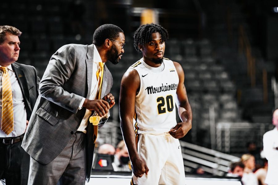 Mens basketball assistant Frank Young instructs senior guard Adrian Delph during the Mountaineers eight-point victory over the Warhawks. 