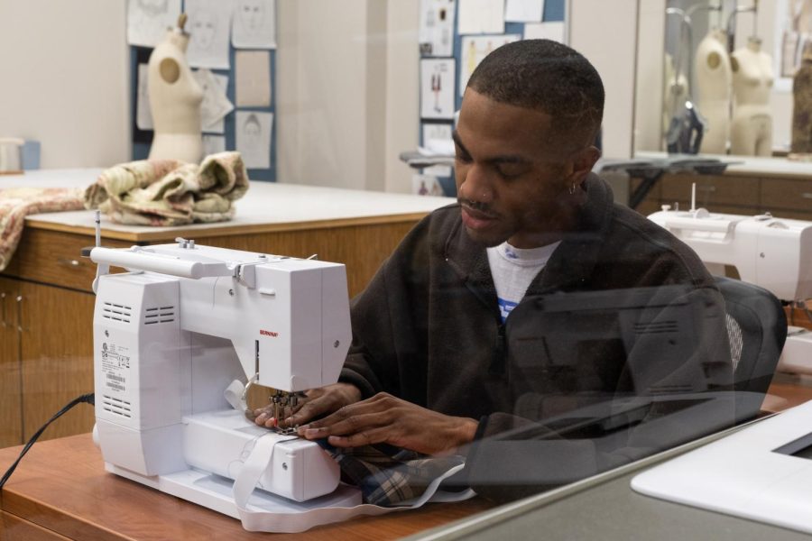 Andre Edwards’ works on a piece Feb. 24, 2022. Not only does Edwards offer custom commissions along with selling his stock, but he also offers alteration services.