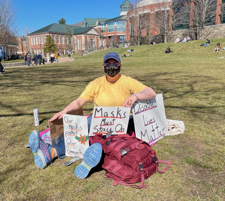 Matt Cottrell holds signs in favor of the mask mandate March 2, 2022.
