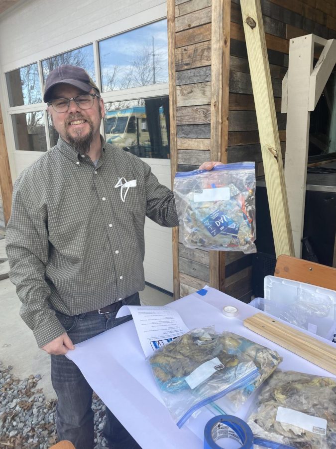 Tom Hansell, App State professor of Appalachian Studies and documentary studies, holds plastic collected from the “Trash Trout” workshop, March 22, 2022.