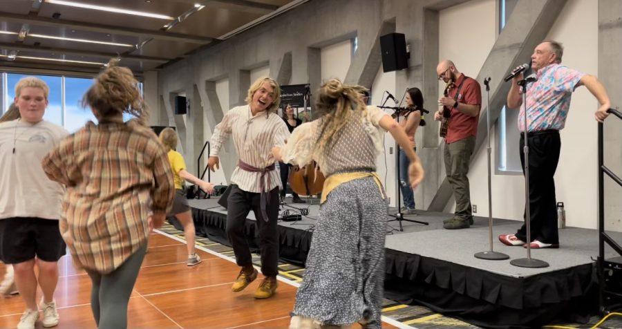 Symposium attendees dance as the Heel Raisers perform in the Plemmons Student Union Parkway Ballroom, March 31, 2022.