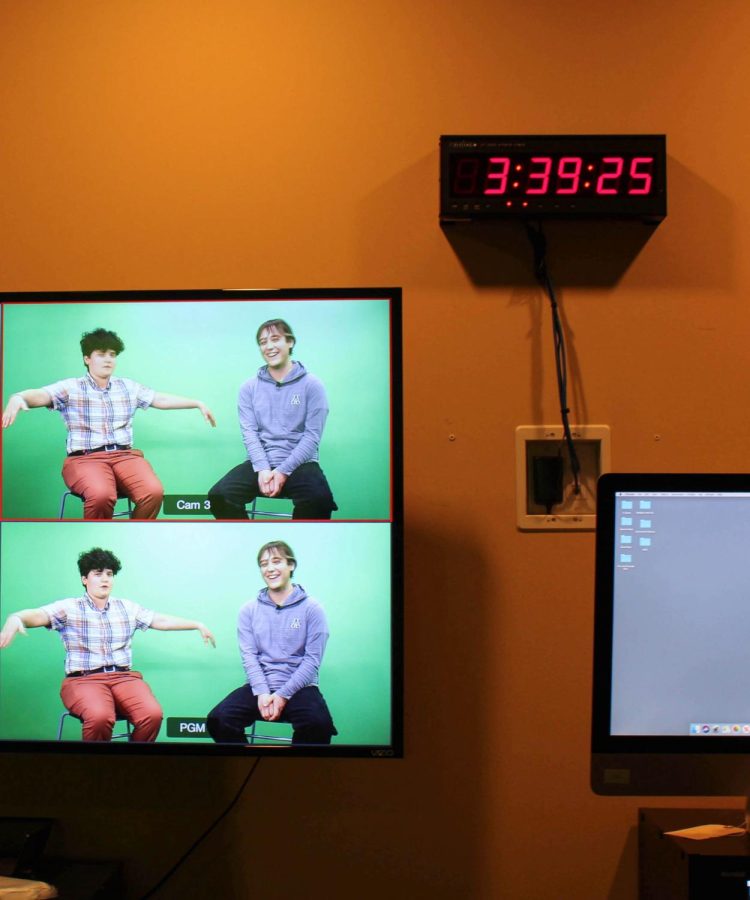 Noah Rabe watches the segment being filmed Feb. 21, 2022. Rabe is in charge of audio and video control for the show.