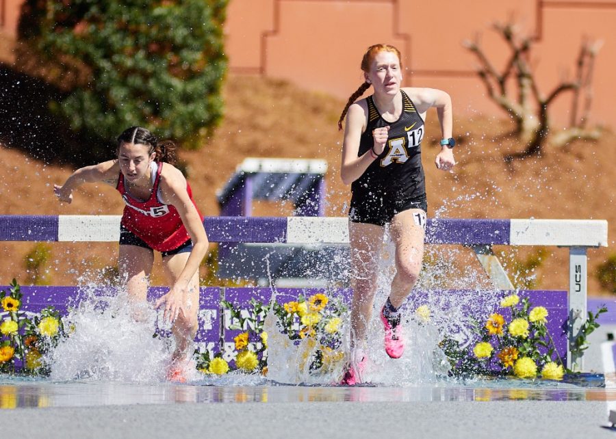 Junior+distance+runner+Claire+Mason+passes+an+opponent+during+the+steeplechase+event+April+4%2C+2022.+