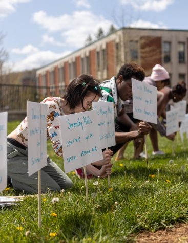 Sustainable development junior Faye Guarino and biology senior Justice Taylor put up signson Sanford Mall April 22, 2022, in memory of transgender people who have been killed in 2021. 