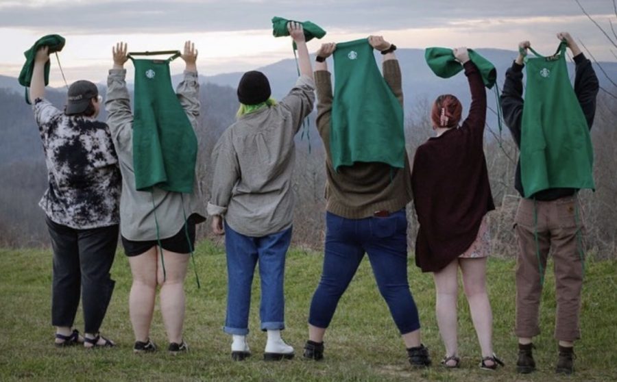 The+Council+of+the+Boone+Starbucks+stand+in+victory+stances+holding+up+their+aprons+April+30%2C+2022.