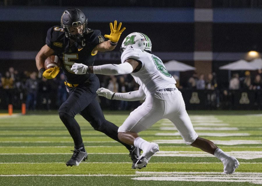 Former App State receiver Thomas Hennigan stiff arms defender in a 31-30 win over Marshall Sept. 23, 2021. Hennigan finished his college career with a program record 242 catches.
