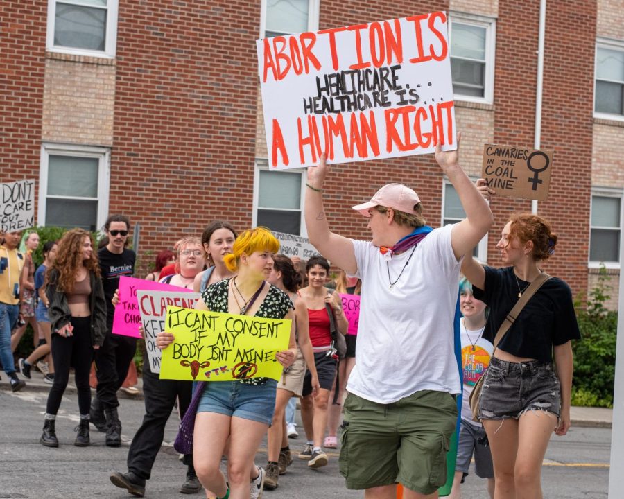 With his sign held high, App state student Kolby Parker leads demonstrators in their march on June 25, 2022.