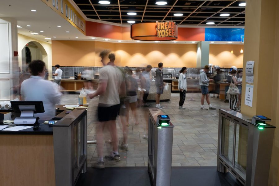 Students wait in line in the Upper section of Roess Dining Hall. To get into the dining hall, one swipe is required, and to get a carry out tray requires an additional swipe.