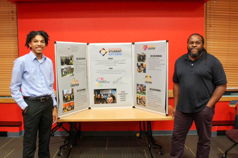  Christian Martin and Will Sheppard pictured by an Intercultural Student Affairs diagram. Martin, pictured on the left, is a student coordinator for the center, and Sheppard, pictured on the right, is the Associate Director of Intercultural Student Affairs. July 26.