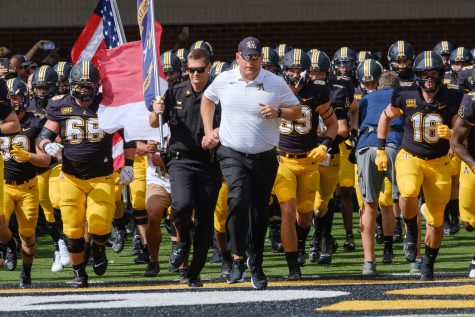 App State football head coach Shawn Clark leads his team into Kidd Brewer Stadium for the first time during his second season in the role Sept. 18, 2021. Clark opens his third season as the Mountaineer head coach in 2022 against North Carolina.