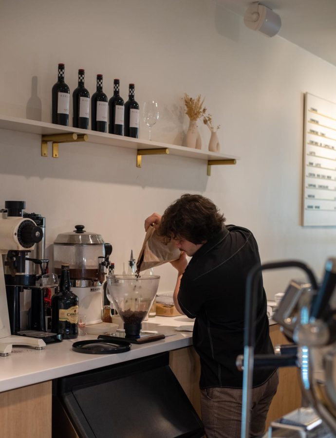 Baristo+Leon+pouring+whole+espresso+beans%2C+preparing+to+be+ground+July+20%2C+2022.+Venture+offers+hot+espresso+drinks+like+cappuccinos+and+lattes%2C+as+well+as+cold+drinks+like+their+cacao+cold+brew.+Both+drinks%2C+along+with+others%2C+are+served+at+the+chocolate+lounge+on+the+ground+level+floor.