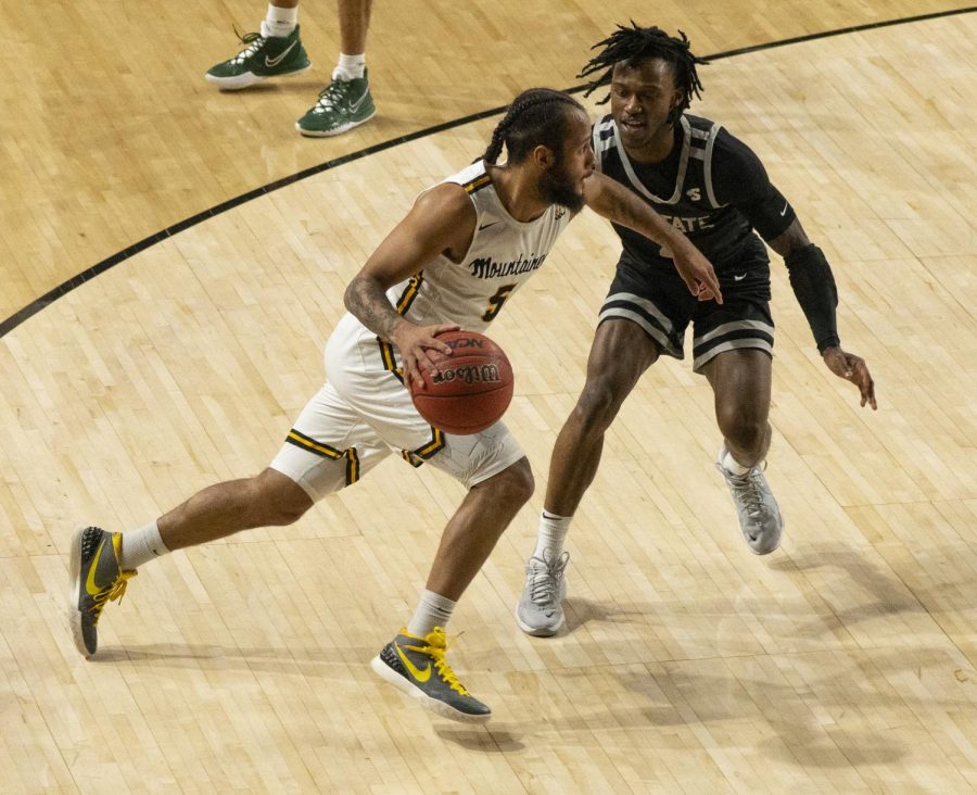 Former Mountaineer guard Michael Almonacy drives past a USC Upstate defender in his final collegiate game March 15, 2022. 