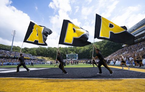The App State cheer team runs the App State flags across the end zones after sophomore wide receiver Christian Horn’s touchdown in the fourth quarter Sept. 3, 2022.