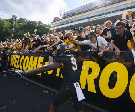 Redshirt sophomore receiver Christian Wells excites the Mountaineer student section during App States Sept. 3, 2022, battle with North Carolina. 