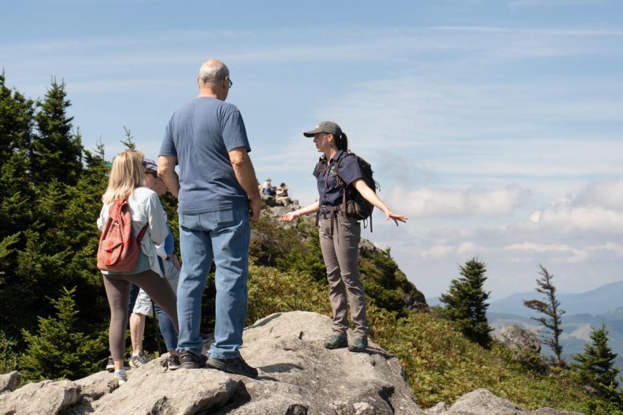 Paige Folk, right, an environmental educator at Grandfather Mountain, teaches a group about the natural communities surrounding the Mile High Swinging Bridge. 
