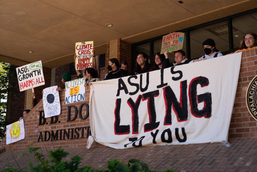 ClimACT protesters hold signage outside the B.B. Dougherty Administration Building after being told to leave over “disturbing a meeting” with their chants and demands for more environmentally sustainable university policies Sept. 28, 2022.