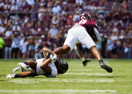 Junior defensive back Nick Ross pulls Aggies tight end Donovan Green down to the turf Sept. 10, 2022. Ross finished with a team-high seven tackles.