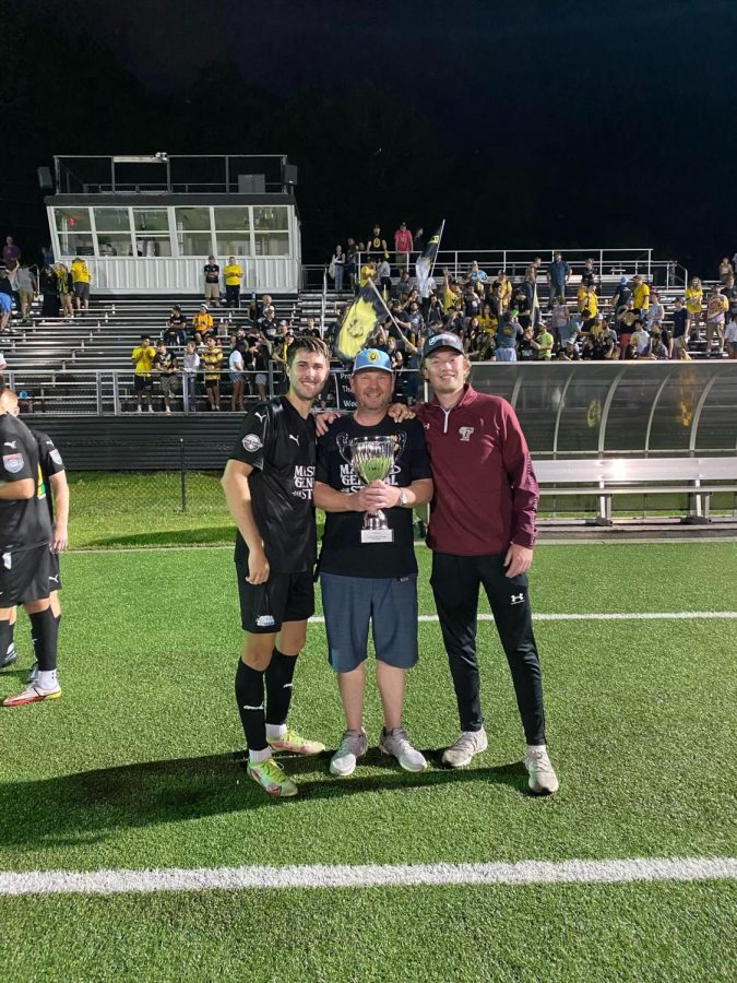Jason O’Keefe, middle, poses with the conference championship trophy alongside former App State players Camden Holbrook, left, and Nick Buchholz, right, July 16, 2022.