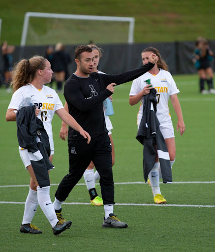 Assistant coach Mark Catteral gives tips to first year midfielder Lela Stark after the first half ends. Stark, who is from Guelph, Ontario, Canada, had two shots against Coastal Carolina, Sept. 22. The Mountaineers went on to win 2-1 over the Chanticleers.