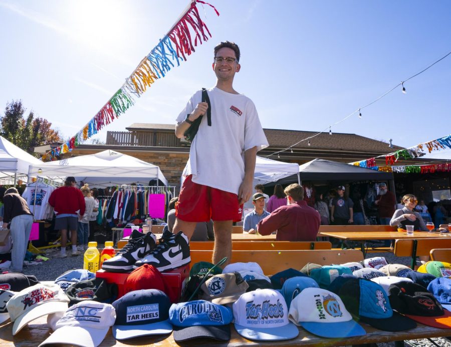 Nick Pianovich, of Alley-Oop Culture Exchange, poses in front of his merchandise at the vintage market at Appalachian Mountain Brewery on Oct. 22, 2022.
