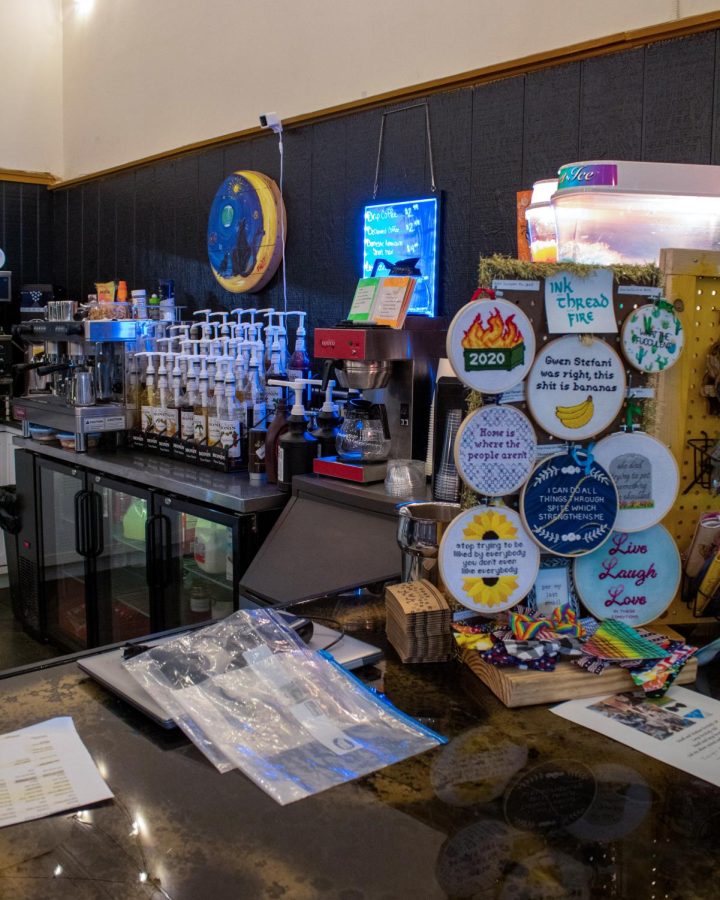 Brews and Mews offers more than just coffee. Stickers, ink threads, and artwork are displayed for sale around the coffee shop. 