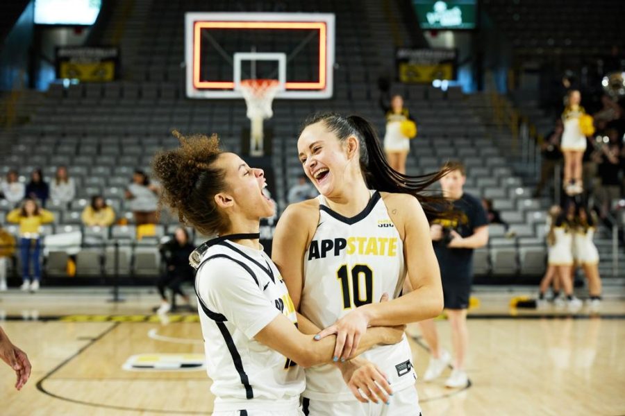 Sophomore guards Emily Carver and Zada Porter celebrate a seven-point victory behind Carvers career-high 27 points Jan. 21, 2022. 