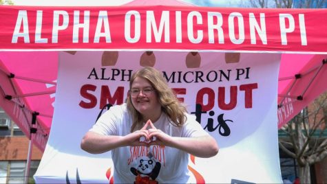 Margaret “Marge” Young shows off the AOII hand sign at the sorority’s charity barbecue fundraiser. March 15, 2023.