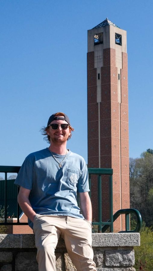 Senior Jake Schantz, a risk management and insurance major and member of App State’s Kappa Sigma chapter poses for a photo in front of the Steam Plant tower. March 18, 2023.